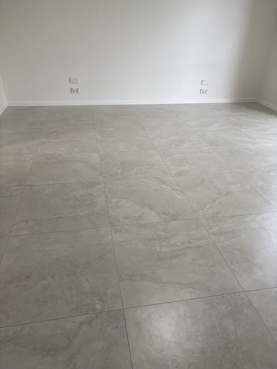 Large-format floor tiles across an open living area